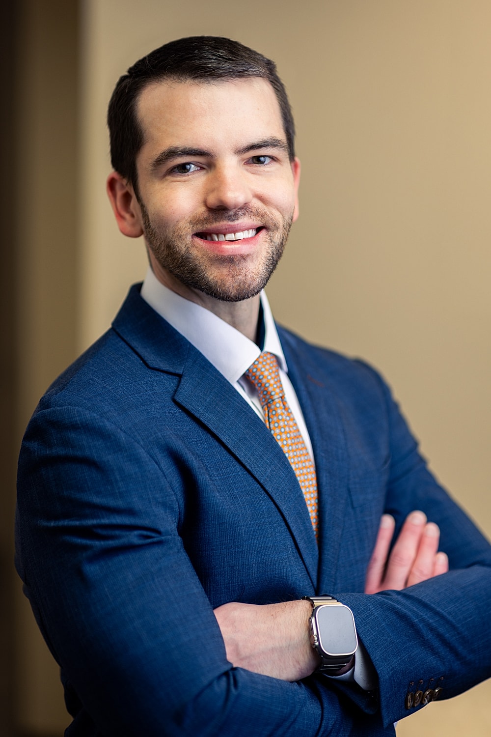 Professional man smiling in formal attire.