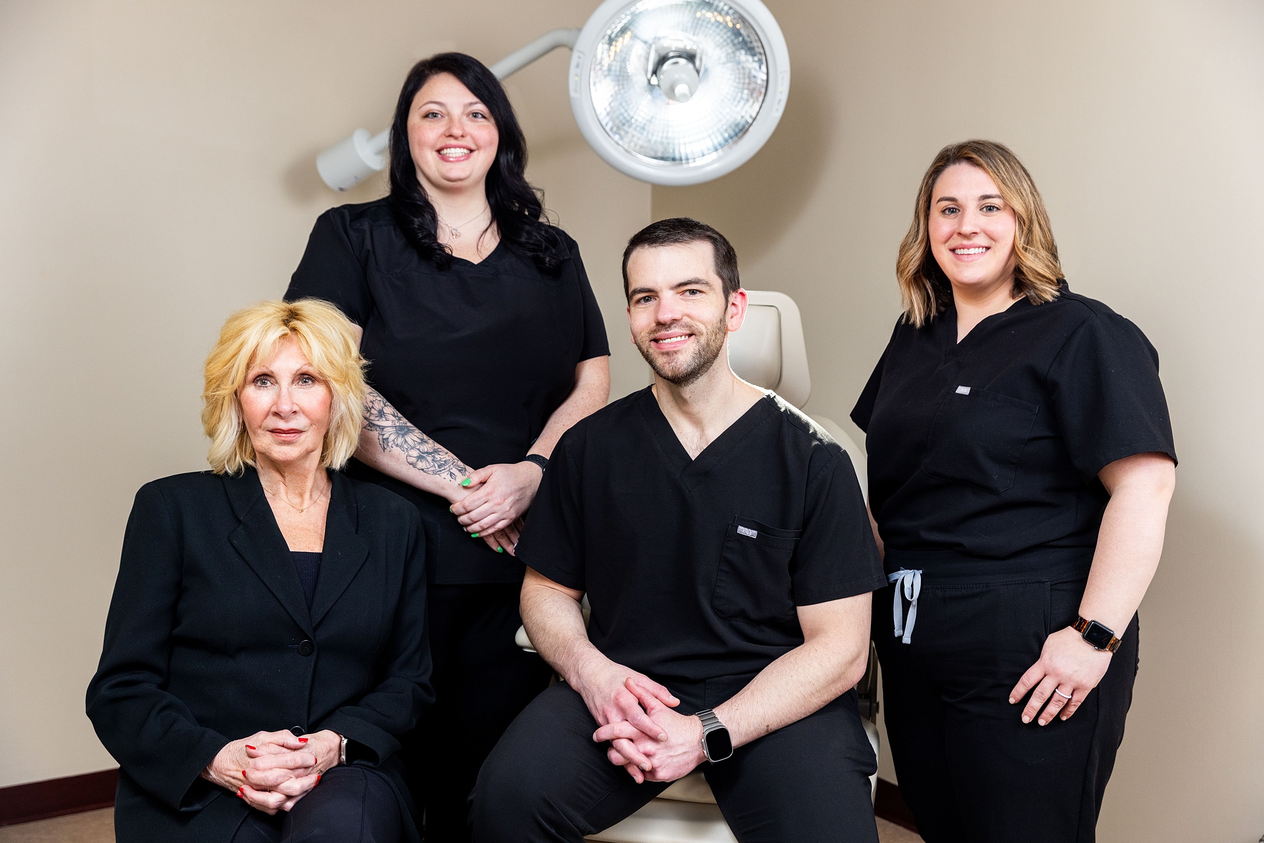Medical team posing together in clinic setting.